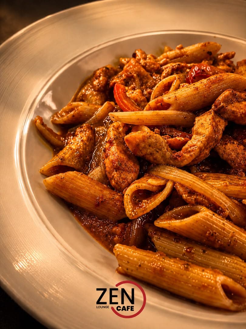Penne pasta tossed with grilled chicken strips, chili, and garlic in a rich tomato sauce, finished with cracked black pepper.